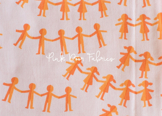 Cotton quilting fabric pattern called 'Paper Dolls in Pink Orange'. Part of the 'Kinder' fabric collection. Designed by Heather Ross for fabric company Windham Fabrics. SKU: 43485-10. 44-45 inch width.
