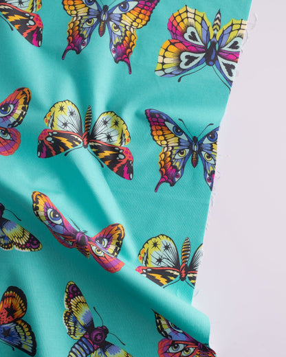 Cotton quilting fabric pattern called 'Butterfly Hugs in Lagoon'. Part of the 'Daydreamer' fabric collection. Designed by Tula Pink for fabric company Free Spirit Fabrics. SKU: PWTP171.LAGOON. 44-45 inch width.