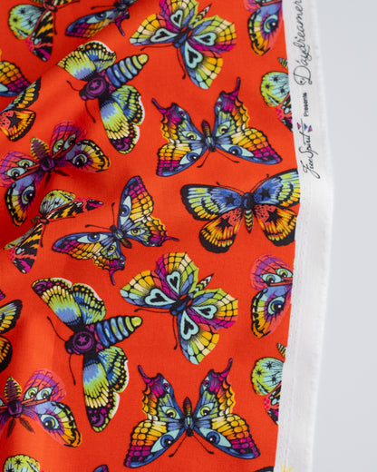 Cotton quilting fabric pattern called 'Butterfly Kisses in Papaya'. Part of the 'Daydreamer' fabric collection. Designed by Tula Pink for fabric company Free Spirit Fabrics. SKU: PWTP172.PAPAYA. 44-45 inch width.