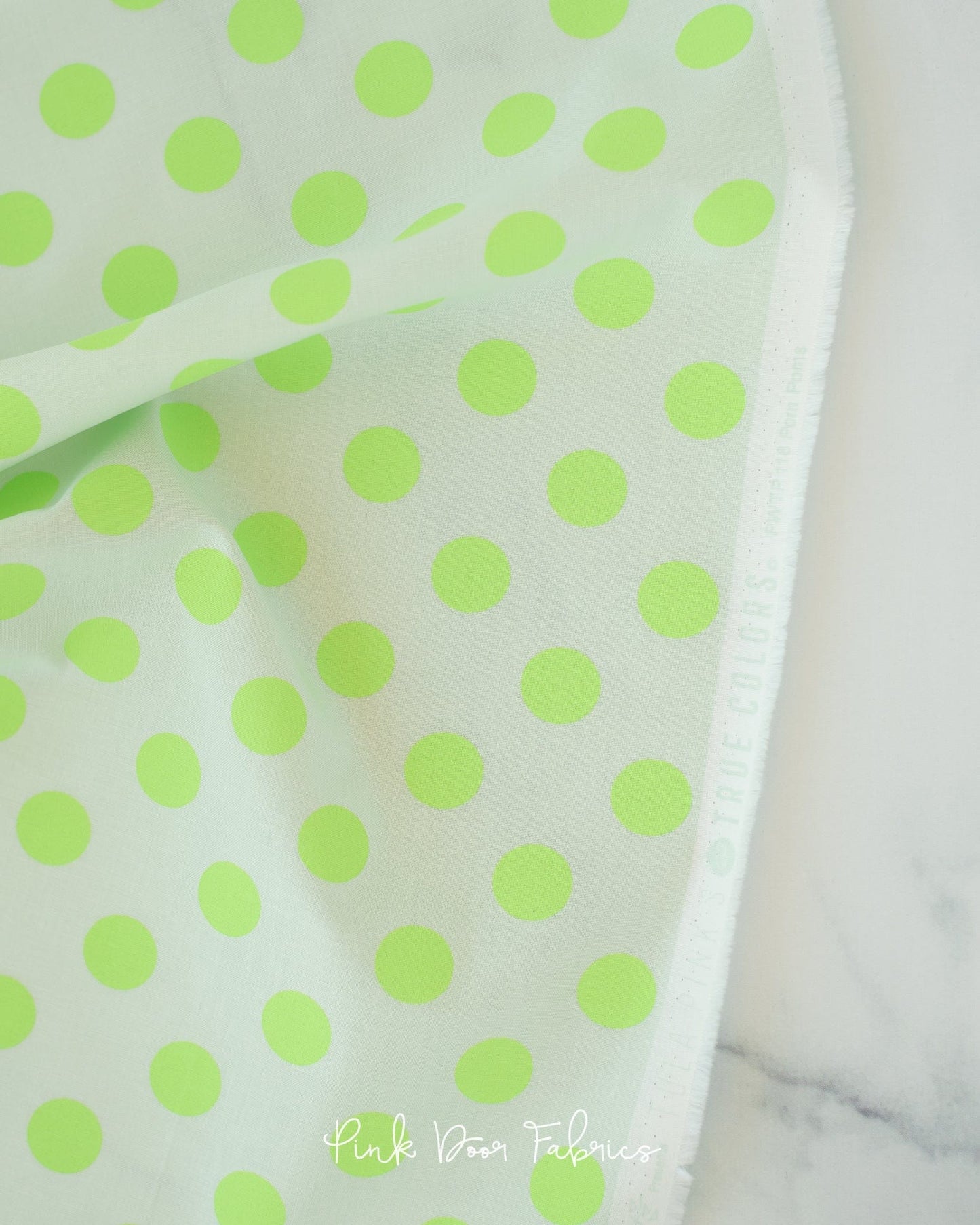 Cotton quilting fabric pattern called 'Pom Poms in Karma'. Part of the '2023 True Colors' fabric collection. Designed by Tula Pink for fabric company Free Spirit Fabrics. SKU: PWTP118.KARMA. 44-45 inch width.