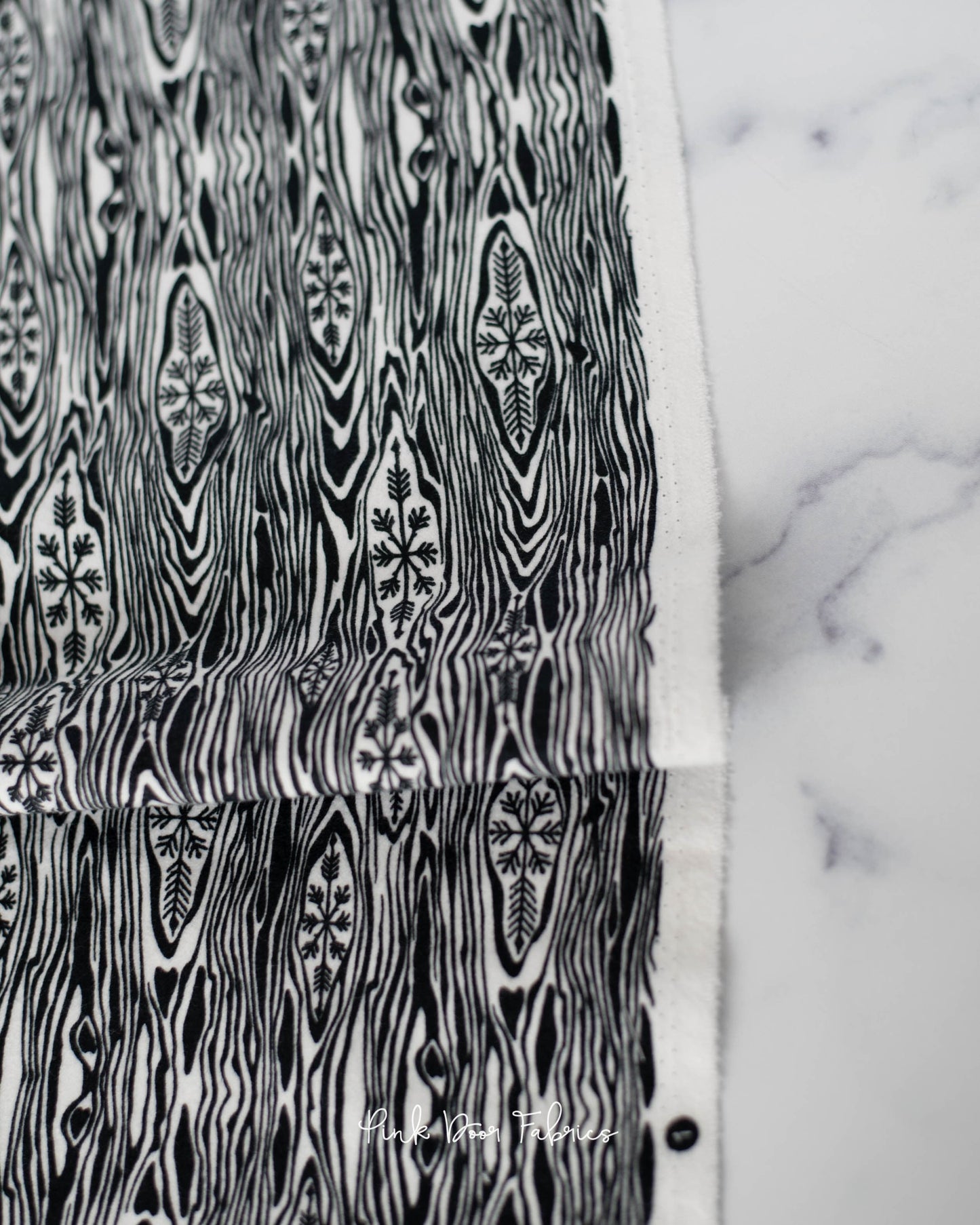 Cotton flannel quilting fabric pattern called 'Yule Log in Ink'. Part of the 'Holiday Homies flannel' fabric collection. Designed by Tula Pink for the Free Spirit Fabrics fabric company. SKU: FNTP006.INK. 44-45 inch width.