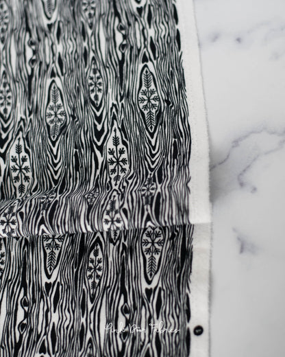 Cotton flannel quilting fabric pattern called 'Yule Log in Ink'. Part of the 'Holiday Homies flannel' fabric collection. Designed by Tula Pink for the Free Spirit Fabrics fabric company. SKU: FNTP006.INK. 44-45 inch width.