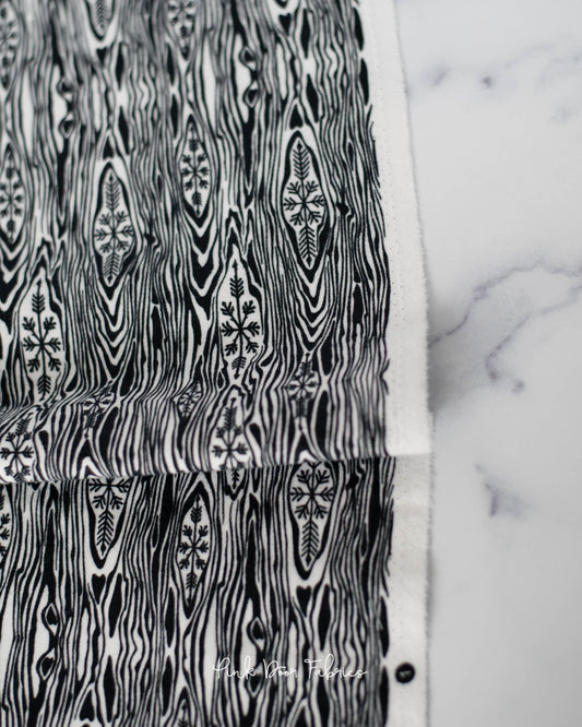 Cotton flannel quilting fabric pattern called 'Yule Log in Ink'. Part of the 'Holiday Homies flannel' fabric collection. Designed by Tula Pink for the Free Spirit Fabrics fabric company. SKU: FNTP006.INK. 44-45 inch width.