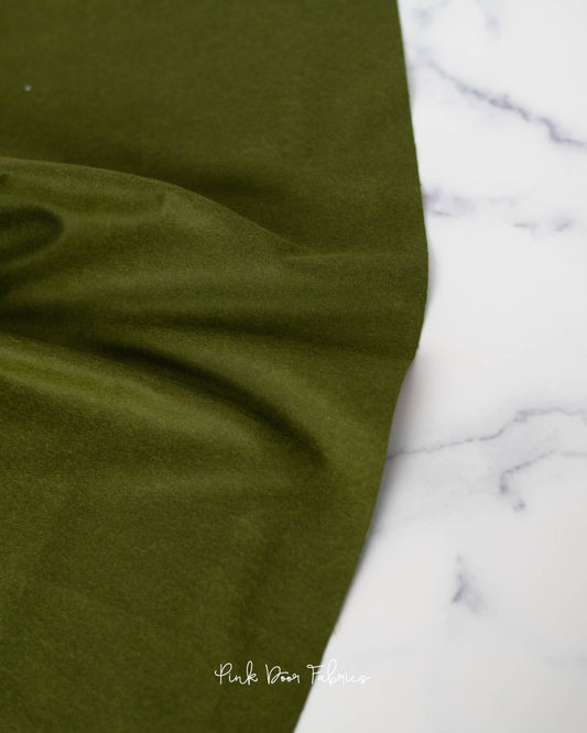 Cotton flannel quilting fabric pattern called 'Solid in Pine Fresh'. Part of the 'Holiday Homies flannel' fabric collection. Designed by Tula Pink for the Free Spirit Fabrics fabric company. SKU: FNTP007.PINEFRESH. 44-45 inch width.