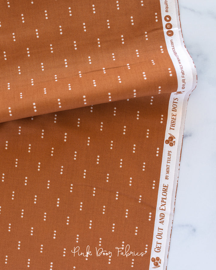 Cotton quilting fabric pattern called 'Three Dots in Clay'. Part of the 'Get Out and Explore' fabric collection. Designed by Mint Tulip for fabric company Cotton + Steel. SKU: MT103-CL2. 44-45 inch width.