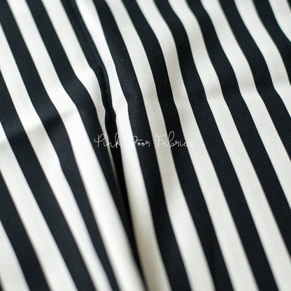 Cotton quilting fabric pattern called 'Tent Stripe in Paper'. Part of the 'Linework' fabric collection. Designed by Tula Pink for fabric company Free Spirit Fabrics. SKU: PWTP069.PAPER. 44-45 inch width.