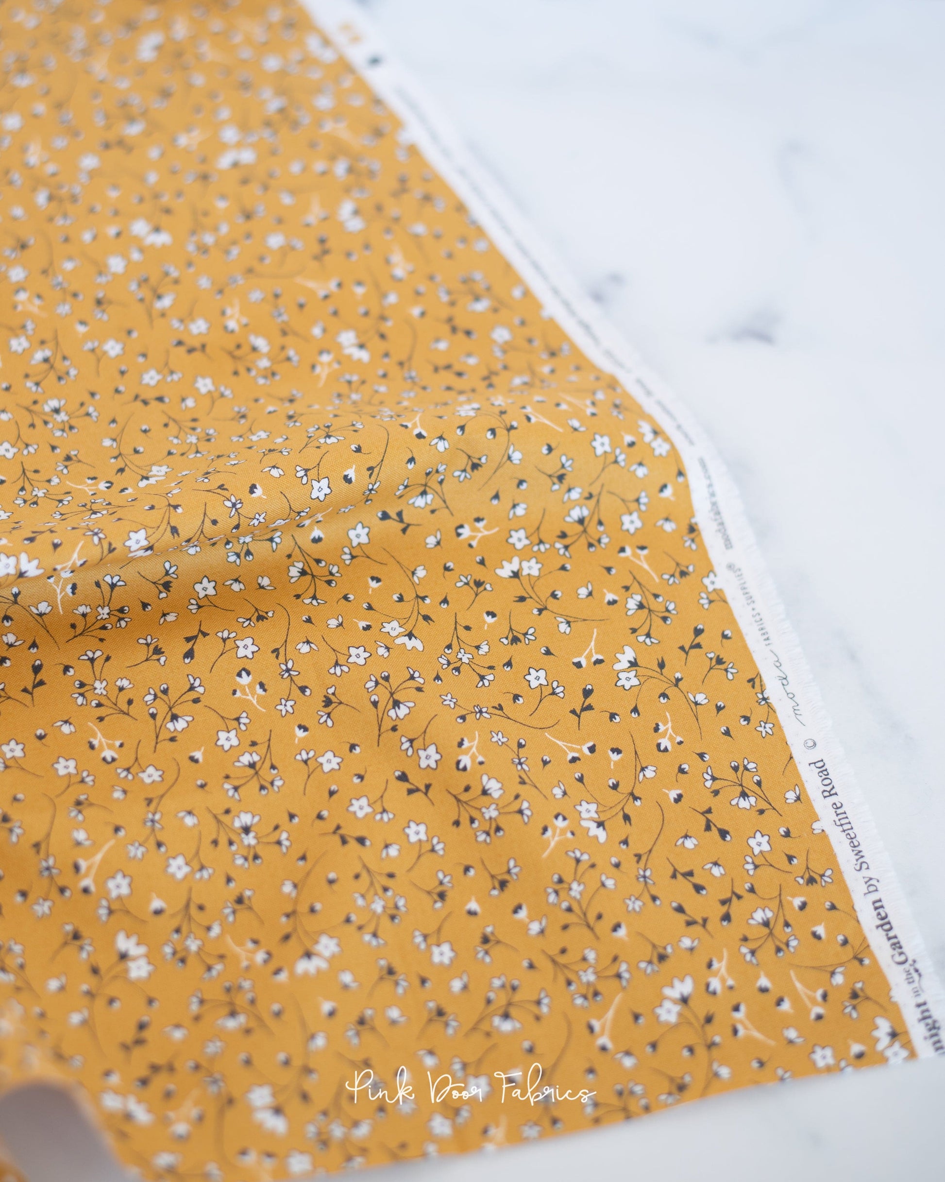 Cotton quilting fabric pattern called 'Pocketfull of Posies in Gold'. Part of the 'Midnight in the Garden' fabric collection. Designed by Fancy That Design House & Co. for fabric company Moda Fabrics. SKU: 43123 12. 44-45 inch width.