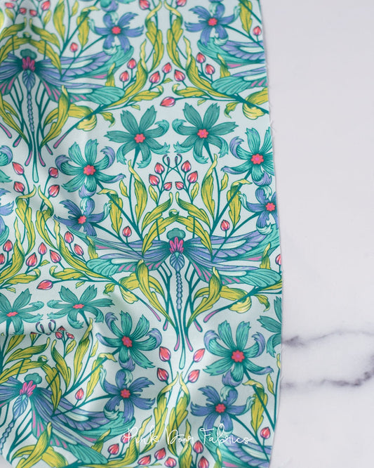 Cotton quilting fabric pattern called 'Dragon Your Feet in Dawn'. Part of the 'Moon Garden' fabric collection. Designed by Tula Pink for fabric company Free Spirit Fabrics. SKU: PWTP199.DAWN. 44-45 inch width.
