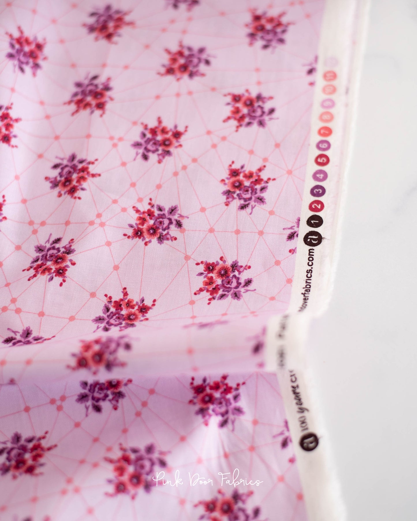 Cotton quilting fabric pattern called 'Little Bouquets in Candy'. Part of the 'Nonna' fabric collection. Designed by Giucy Giuce for fabric company Andover Fabrics. SKU: A-9874-E. 44-45 inch width.