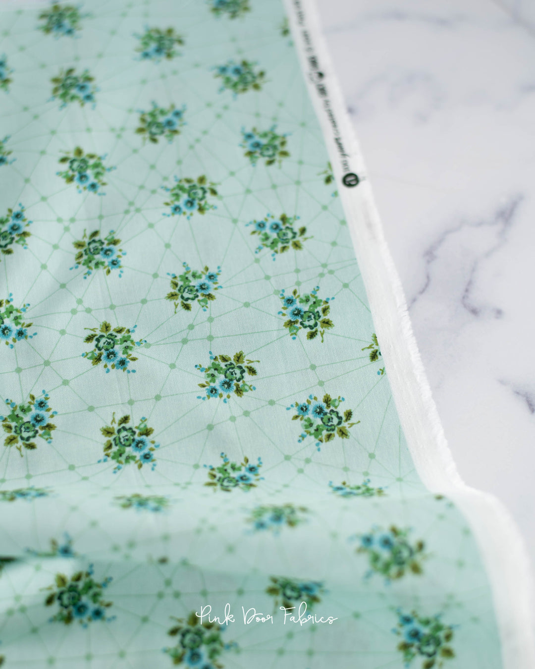 Cotton quilting fabric pattern called 'Little Bouquets in Mint'. Part of the 'Nonna' fabric collection. Designed by Giucy Giuce for fabric company Andover Fabrics. SKU: A-9874-G. 44-45 inch width.