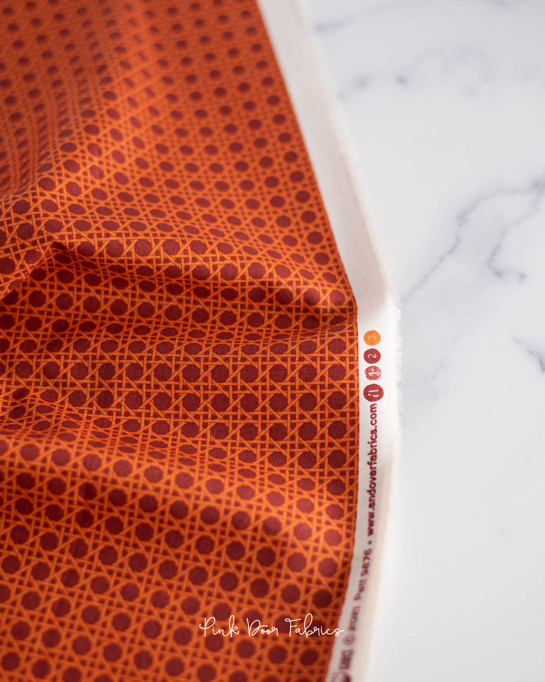 Cotton quilting fabric pattern called 'Caning in Sun-dried Tomato'. Part of the 'Nonna' fabric collection. Designed by Giucy Giuce for fabric company Andover Fabrics. SKU: A-9876-O. 44-45 inch width.