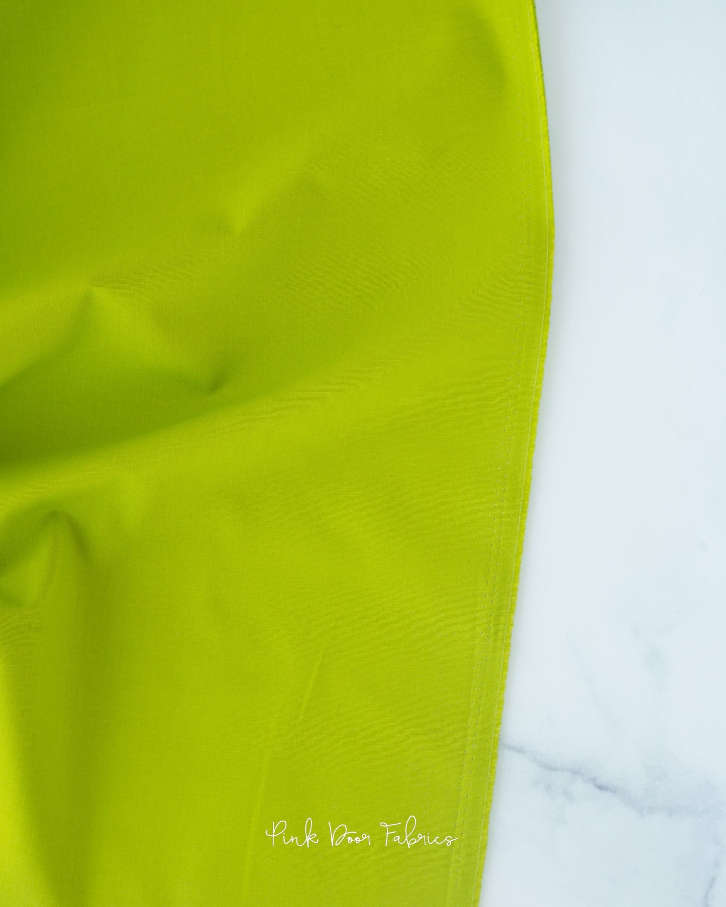 Cotton quilting fabric pattern called 'Solid in Matcha'. Part of the 'Colorworks Solids' fabric collection. Designed by Northcott Fabrics for fabric company Northcott Fabrics. SKU: 9000-726. 44-45 inch width.