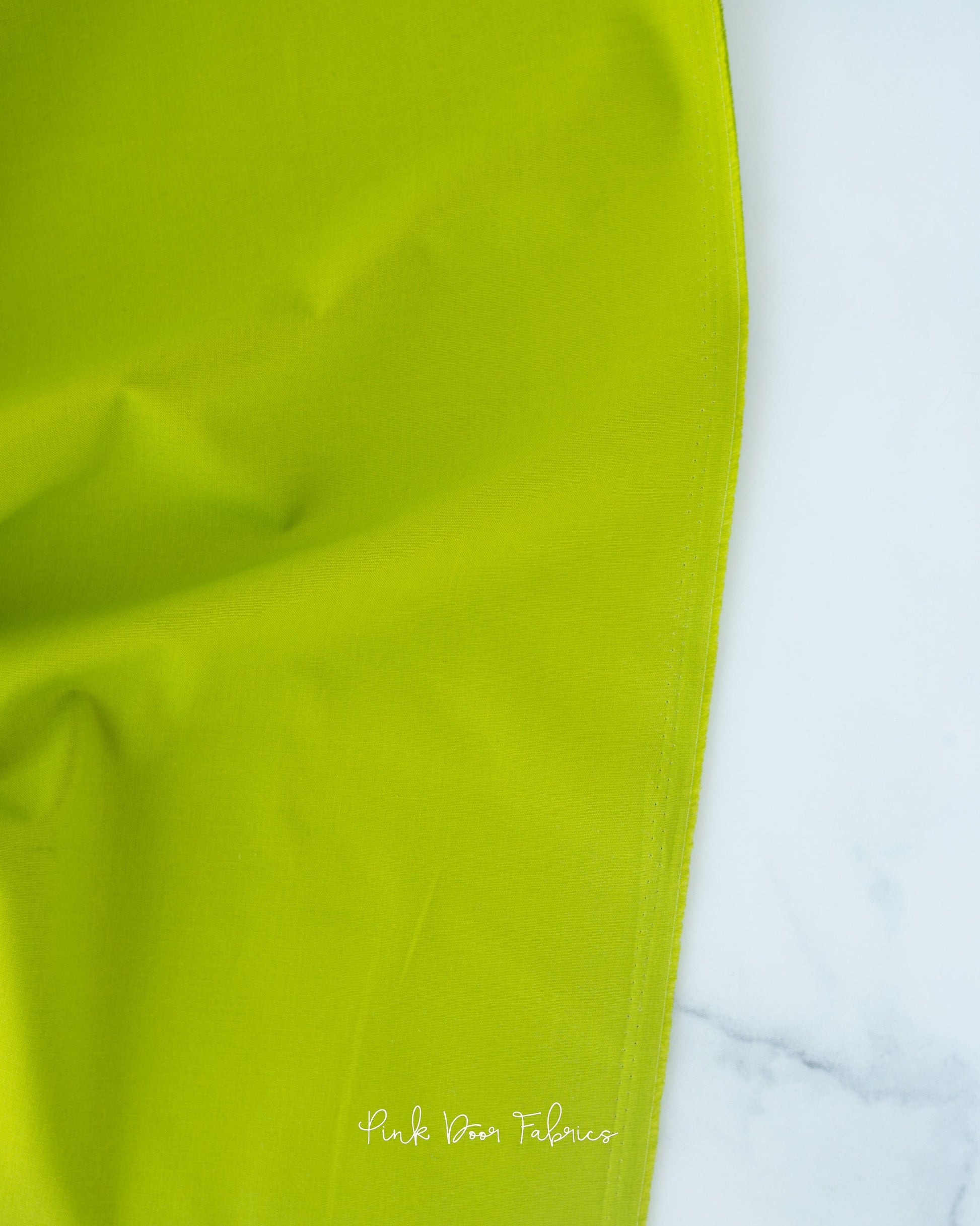Cotton quilting fabric pattern called 'Solid in Matcha'. Part of the 'Colorworks Solids' fabric collection. Designed by Northcott Fabrics for fabric company Northcott Fabrics. SKU: 9000-726. 44-45 inch width.
