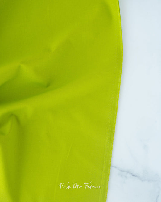 Cotton quilting fabric pattern called 'Solid in Matcha'. Part of the 'Colorworks Solids' fabric collection. Designed by Northcott Fabrics for fabric company Northcott Fabrics. SKU: 9000-726. 44-45 inch width.