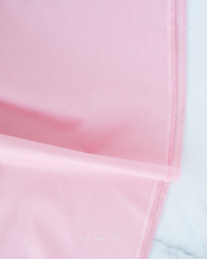 Cotton quilting fabric pattern called 'Solid in Make Me Blush'. Part of the 'Colorworks Solids' fabric collection. Designed by Northcott Fabrics for fabric company Northcott Fabrics. SKU: 9000-201. 44-45 inch width.