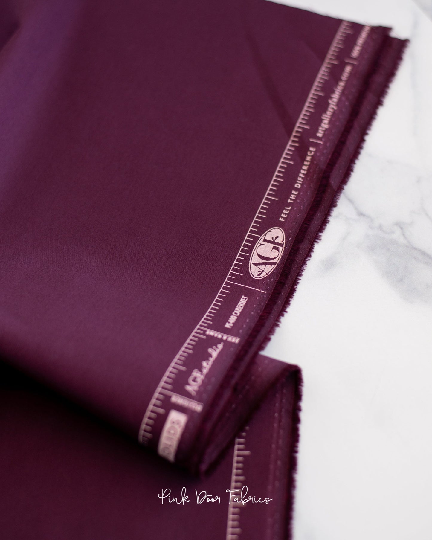 Cotton quilting fabric pattern called 'Cabernet'. Part of the 'Pure Solids' fabric collection. Designed by Art Gallery Fabrics for fabric company Art Gallery Fabrics. SKU: PE-400. 44-45 inch width.