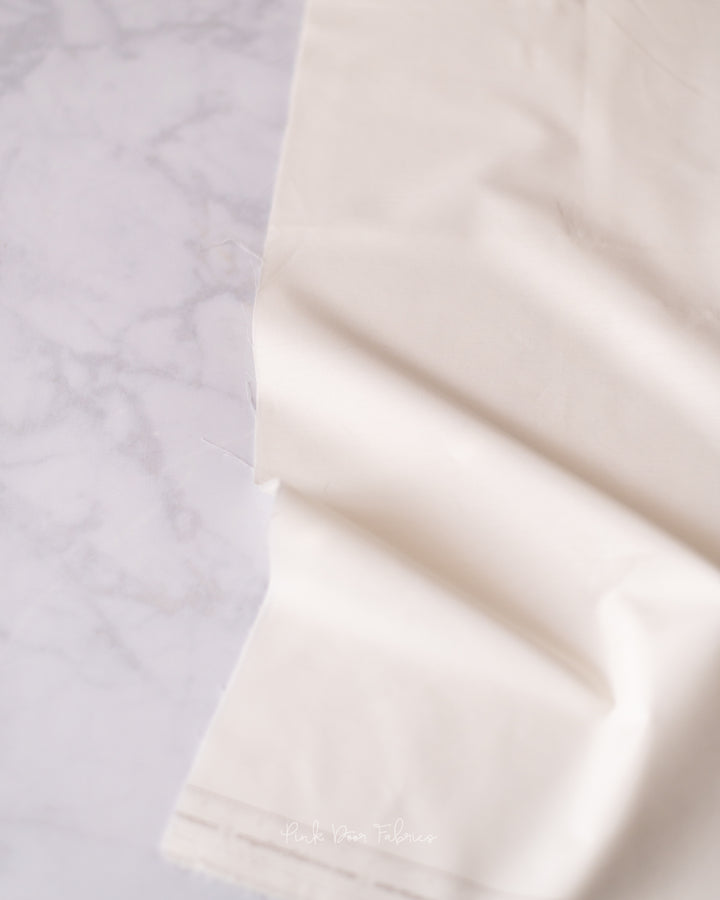 Cotton quilting fabric pattern called 'White Linen'. Part of the 'Pure Solids' fabric collection. Designed by Art Gallery Fabrics for fabric company Art Gallery Fabrics. SKU: PE-408. 44-45 inch width.