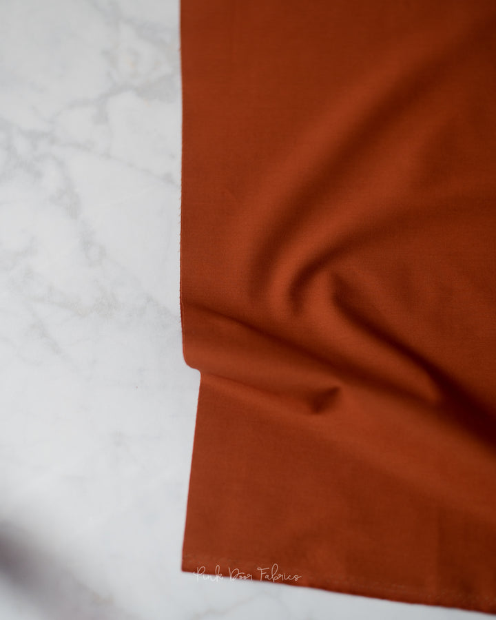 Cotton quilting fabric pattern called 'Chocolate'. Part of the 'Pure Solids' fabric collection. Designed by Art Gallery Fabrics for fabric company Art Gallery Fabrics. SKU: PE-422. 44-45 inch width.