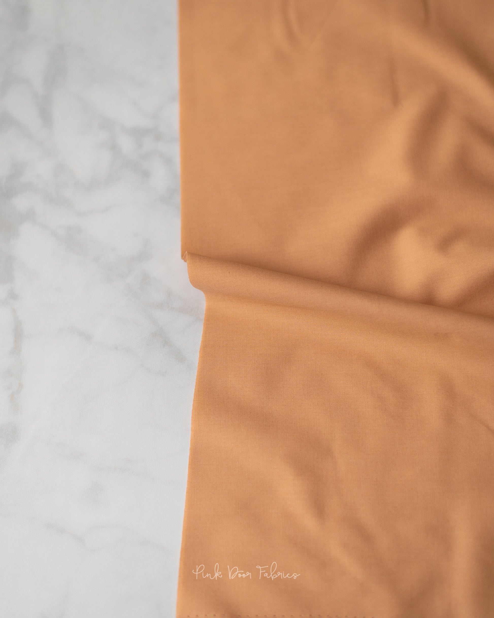 Cotton quilting fabric pattern called 'Toasty Walnut'. Part of the 'Pure Solids' fabric collection. Designed by Art Gallery Fabrics for fabric company Art Gallery Fabrics. SKU: PE-458. 44-45 inch width.