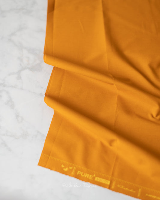 Cotton quilting fabric pattern called 'Raw Gold'. Part of the 'Pure Solids' fabric collection. Designed by Art Gallery Fabrics for fabric company Art Gallery Fabrics. SKU: PE-485. 44-45 inch width.