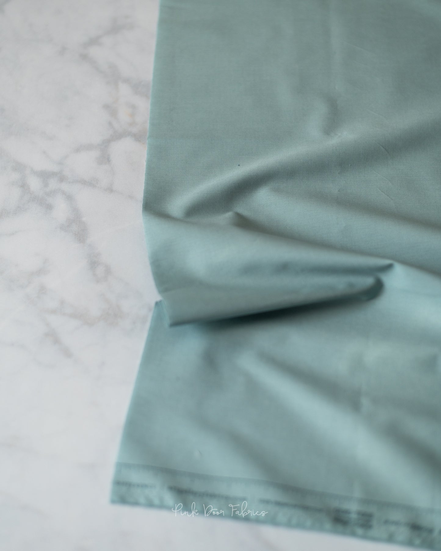 Cotton quilting fabric pattern called 'Ocean Fog'. Part of the 'Pure Solids' fabric collection. Designed by Art Gallery Fabrics for fabric company Art Gallery Fabrics. SKU: PE-500. 44-45 inch width.