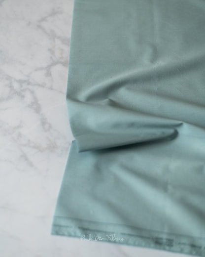Cotton quilting fabric pattern called 'Ocean Fog'. Part of the 'Pure Solids' fabric collection. Designed by Art Gallery Fabrics for fabric company Art Gallery Fabrics. SKU: PE-500. 44-45 inch width.