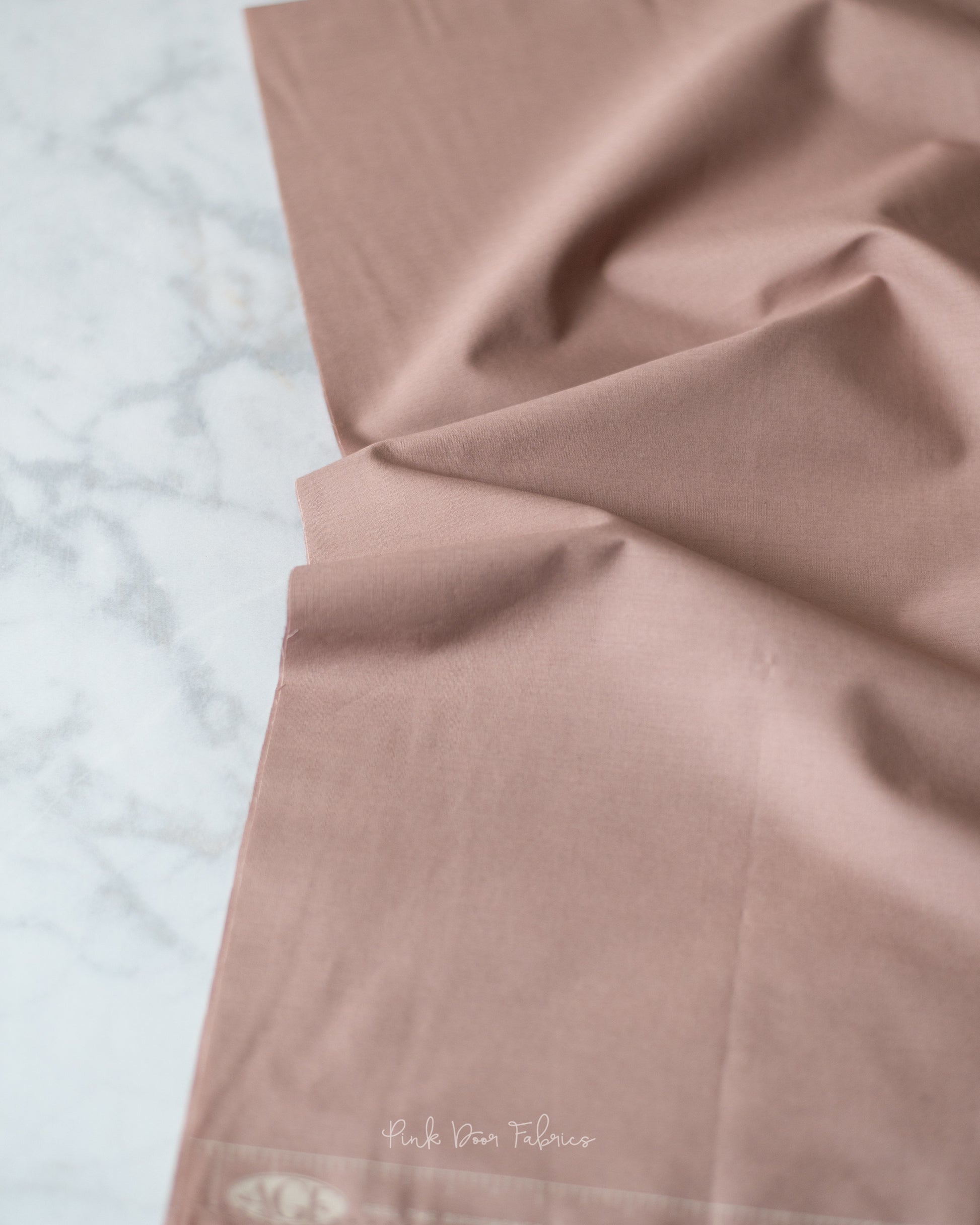 Cotton quilting fabric pattern called 'Potter's Clay'. Part of the 'Pure Solids' fabric collection. Designed by Art Gallery Fabrics for fabric company Art Gallery Fabrics. SKU: PE-507. 44-45 inch width.