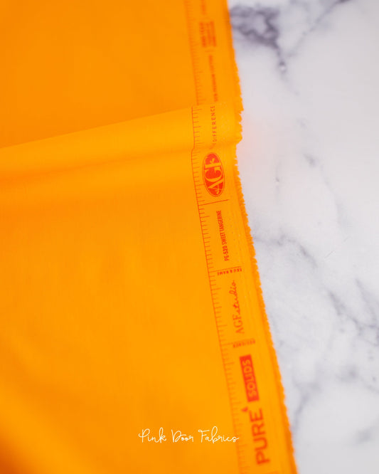 Cotton quilting fabric pattern called 'Sweet Tangerine'. Part of the 'Pure Solids' fabric collection. Designed by Art Gallery Fabrics for fabric company Art Gallery Fabrics. SKU: PE-520. 44-45 inch width.