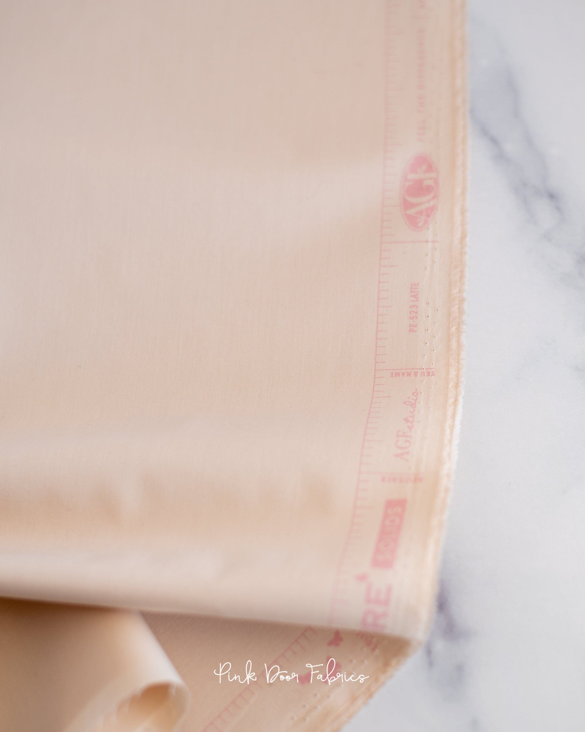 Cotton quilting fabric pattern called 'Latte'. Part of the 'Pure Solids' fabric collection. Designed by Art Gallery Fabrics for fabric company Art Gallery Fabrics. SKU: PE-523. 44-45 inch width.