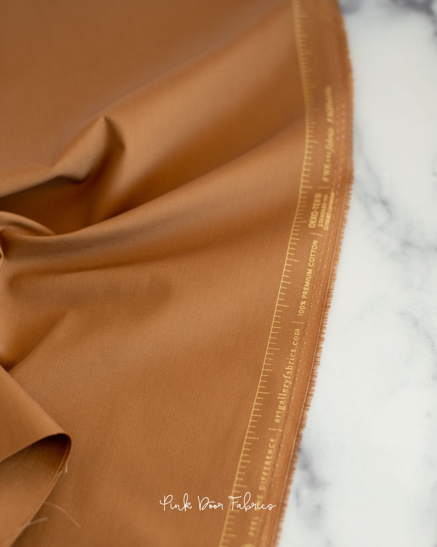 Cotton quilting fabric pattern called 'English Toffee'. Part of the 'Pure Solids' fabric collection. Designed by Art Gallery Fabrics for fabric company Art Gallery Fabrics. SKU: PE-525. 44-45 inch width.