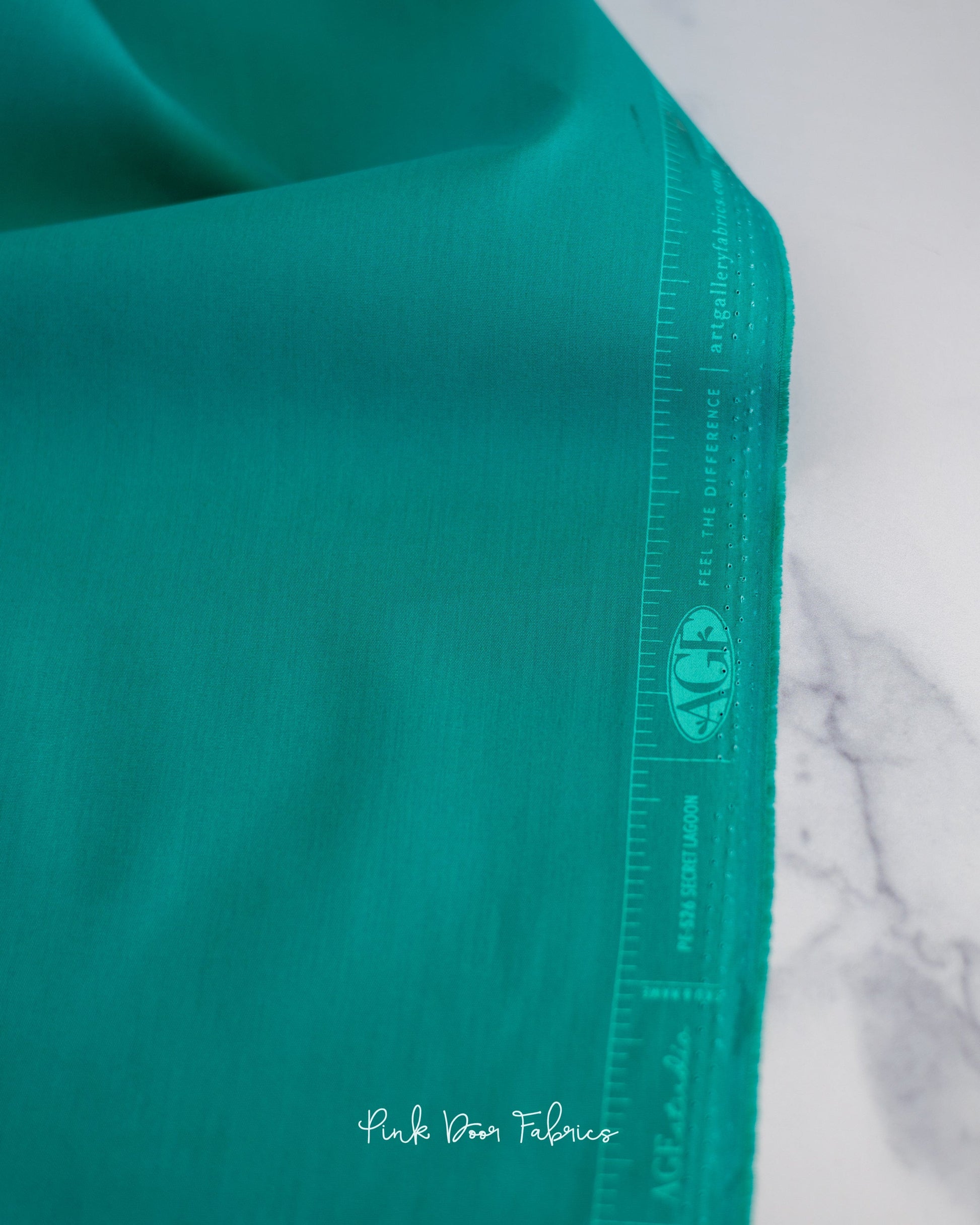 Cotton quilting fabric pattern called 'Secret Lagoon'. Part of the 'Pure Solids' fabric collection. Designed by Art Gallery Fabrics for fabric company Art Gallery Fabrics. SKU: PE-526. 44-45 inch width.