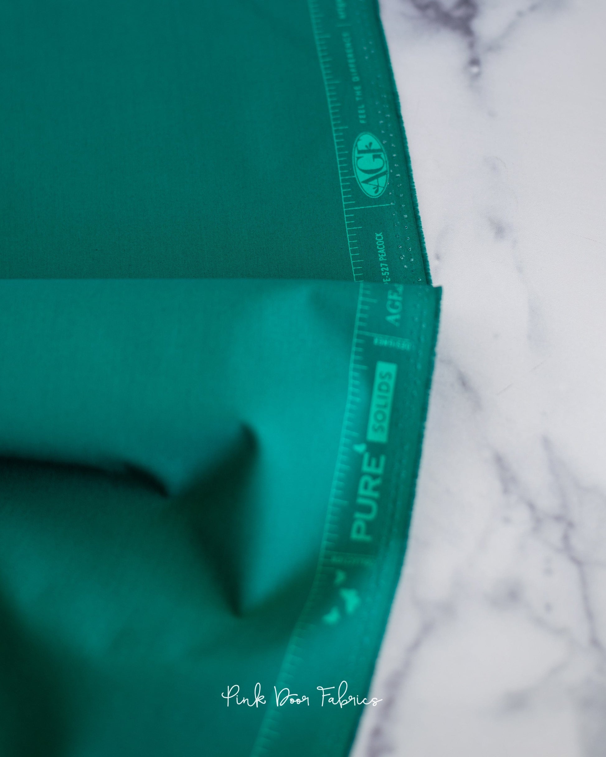 Cotton quilting fabric pattern called 'Peacock'. Part of the 'Pure Solids' fabric collection. Designed by Art Gallery Fabrics for fabric company Art Gallery Fabrics. SKU: PE-527. 44-45 inch width.