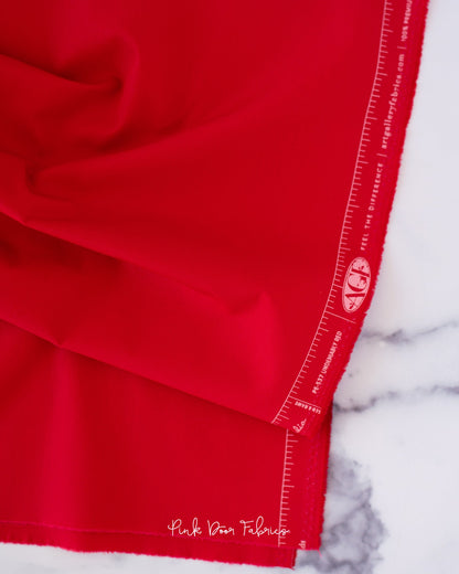 Cotton quilting fabric pattern called 'Undeniably Red'. Part of the 'Pure Solids' fabric collection. Designed by Art Gallery Fabrics for fabric company Art Gallery Fabrics. SKU: PE-537. 44-45 inch width.