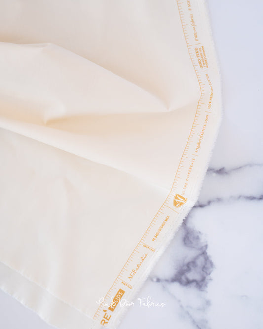 Cotton quilting fabric pattern called 'Coconut Milk'. Part of the 'Pure Solids' fabric collection. Designed by Art Gallery Fabrics for fabric company Art Gallery Fabrics. SKU: PE-540. 44-45 inch width.