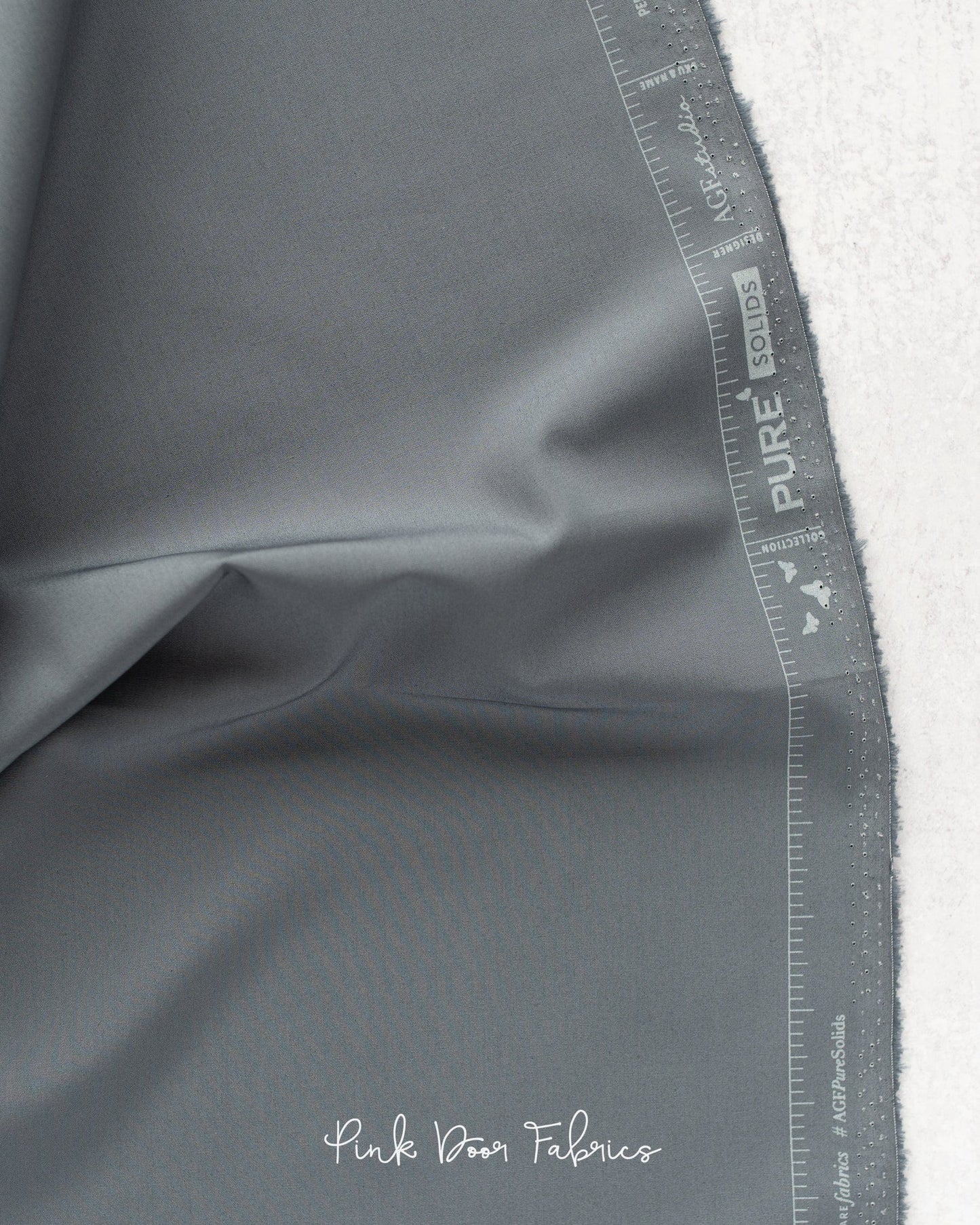 Cotton quilting fabric pattern called 'Slate'. Part of the 'Pure Solids' fabric collection. Designed by Art Gallery Fabrics for fabric company Art Gallery Fabrics. SKU: PE-557. 44-45 inch width.