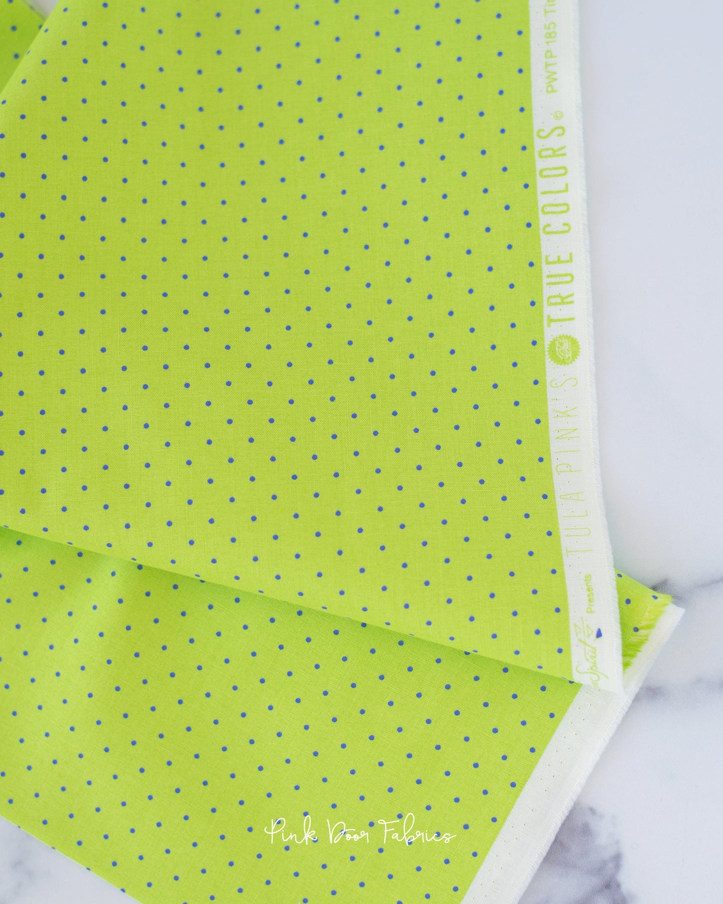 Cotton quilting fabric pattern called 'Tiny Dots in Meadow'. Part of the 'True Colors' fabric collection. Designed by Tula Pink for fabric company Free Spirit Fabrics. SKU: PWTP185.MEADOW. 44-45 inch width.