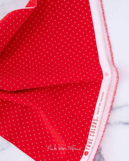 Cotton quilting fabric pattern called 'Tiny Dots in Watermelon'. Part of the 'True Colors' fabric collection. Designed by Tula Pink for fabric company Free Spirit Fabrics. SKU: PWTP185.WATERMELON. 44-45 inch width.