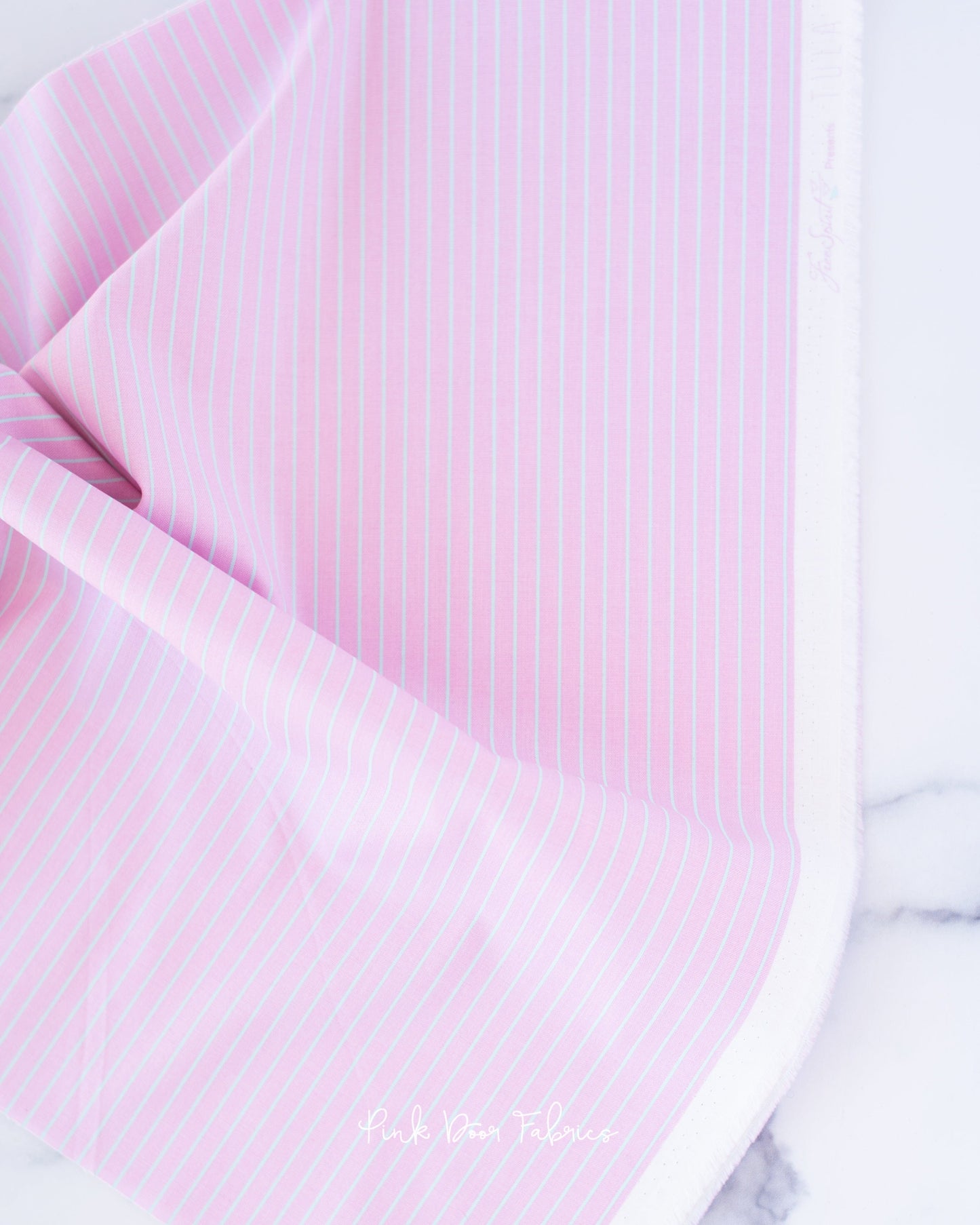 Cotton quilting fabric pattern called 'Tiny Stripes in Petal'. Part of the 'True Colors' fabric collection. Designed by Tula Pink for fabric company Free Spirit Fabrics. SKU: PWTP186.PETAL. 44-45 inch width.