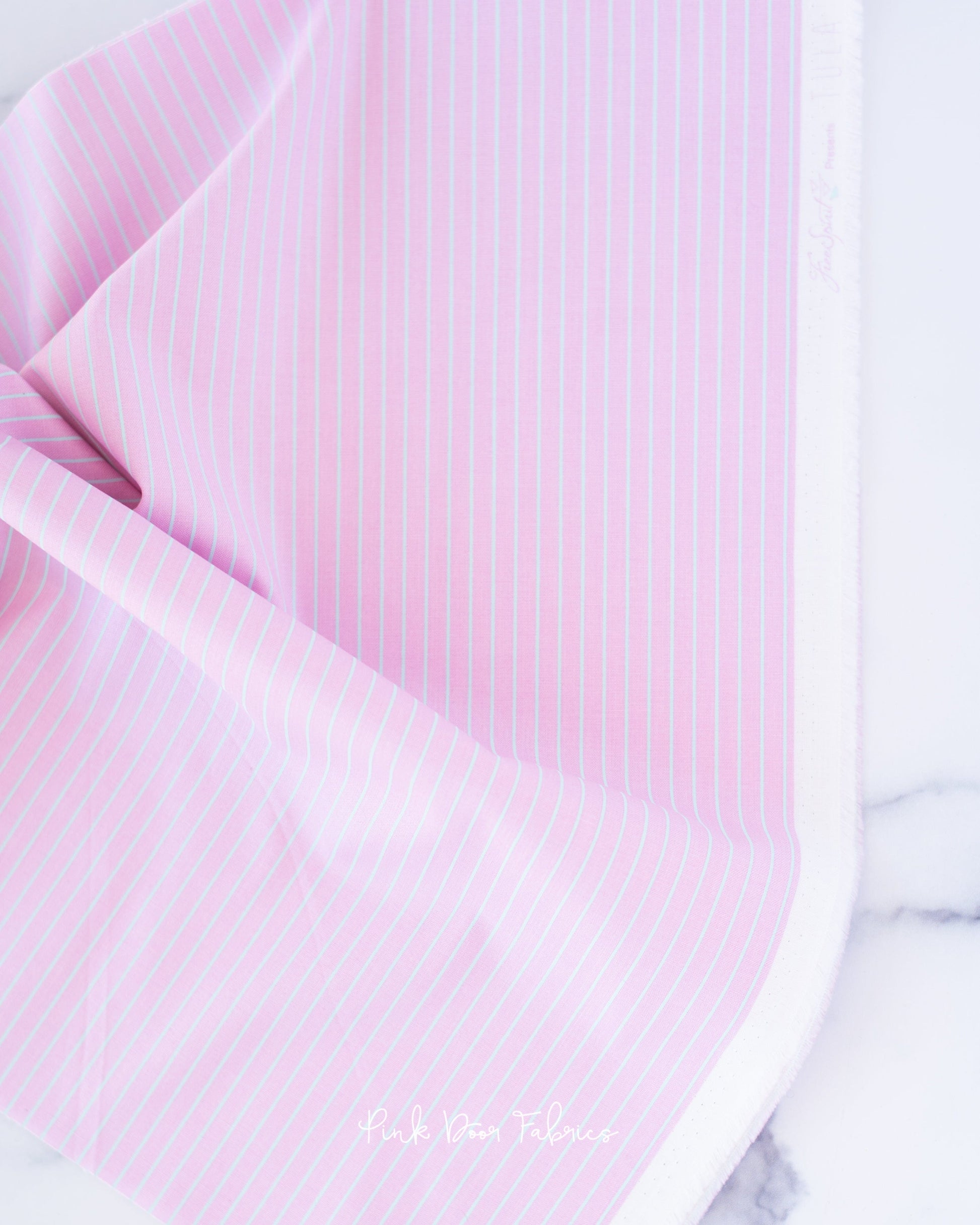 Cotton quilting fabric pattern called 'Tiny Stripes in Petal'. Part of the 'True Colors' fabric collection. Designed by Tula Pink for fabric company Free Spirit Fabrics. SKU: PWTP186.PETAL. 44-45 inch width.