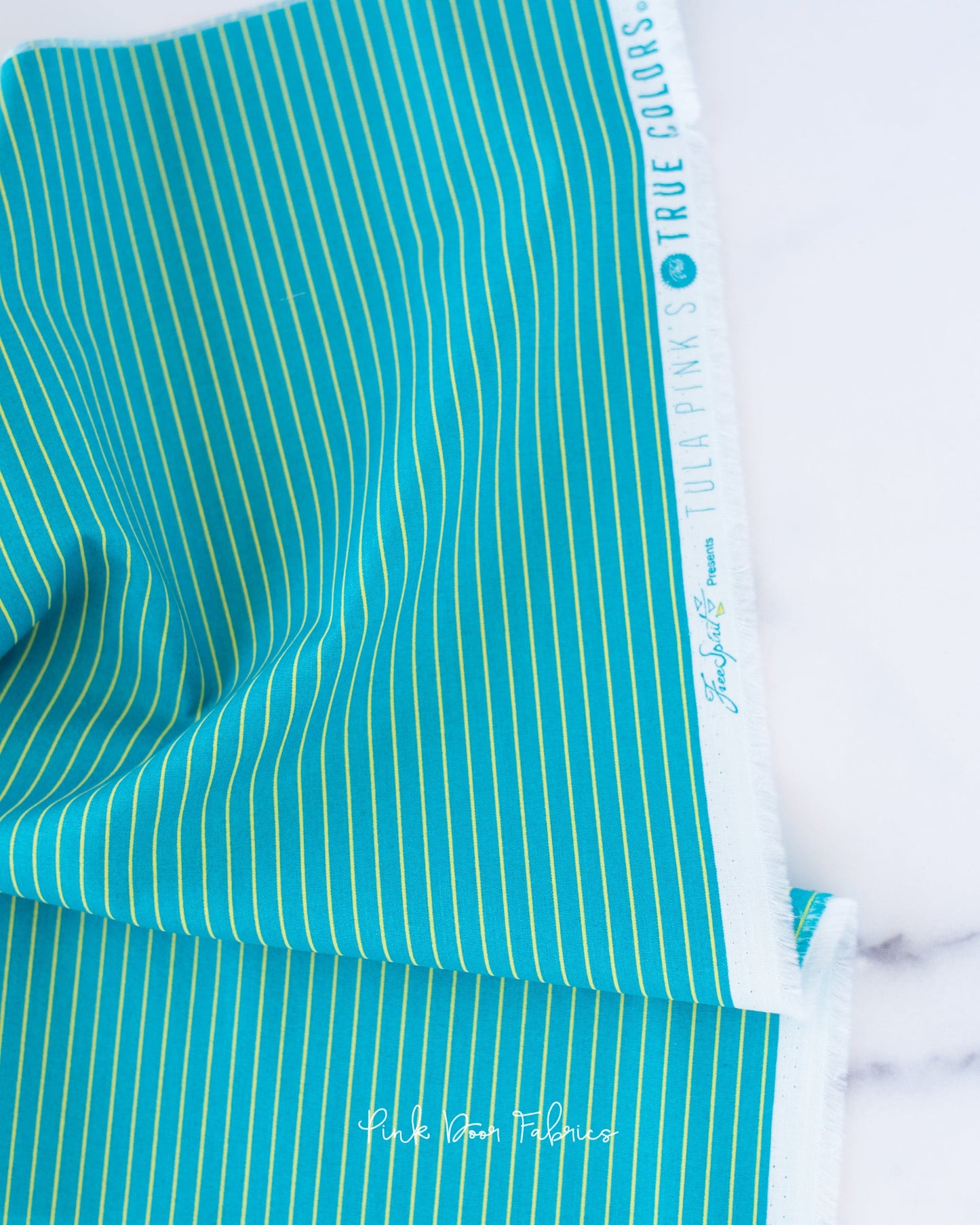 Cotton quilting fabric pattern called 'Tiny Stripes in Songbird'. Part of the 'True Colors' fabric collection. Designed by Tula Pink for fabric company Free Spirit Fabrics. SKU: PWTP186.SONGBIRD. 44-45 inch width.