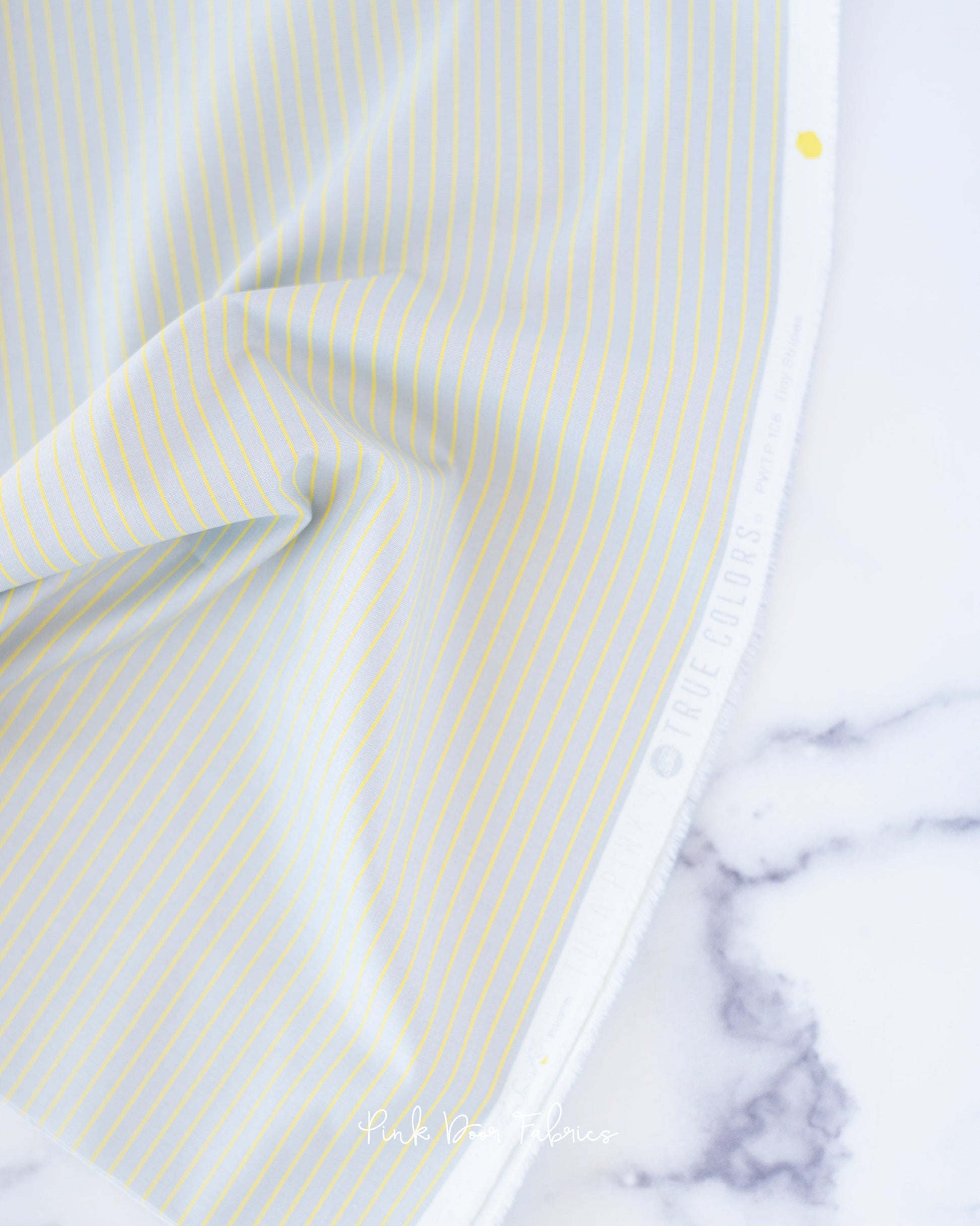 Cotton quilting fabric pattern called 'Tiny Stripes in Spark'. Part of the 'True Colors' fabric collection. Designed by Tula Pink for fabric company Free Spirit Fabrics. SKU: PWTP186.SPARK. 44-45 inch width.