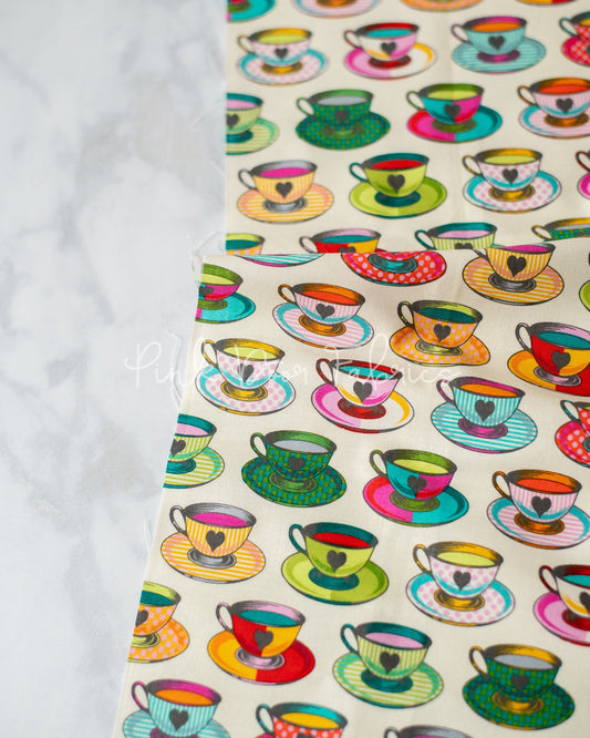 Cotton quilting fabric pattern called 'Tea Time in Sugar'. Part of the 'Curiouser & Curiouser' fabric collection. Designed by Tula Pink for fabric company Free Spirit Fabrics. SKU: PWTP163.SUGAR. 44-45 inch width.