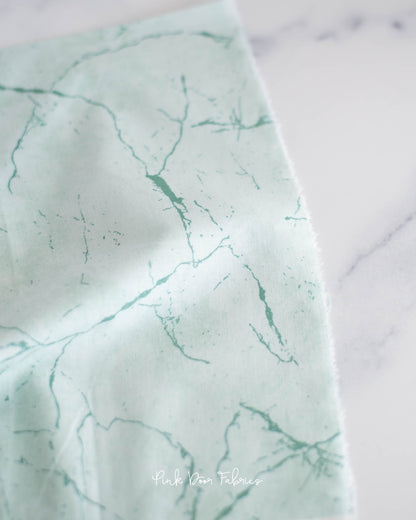 Cotton quilting fabric pattern called 'Pietra in Winter Green'. Part of the 'Pietra' fabric collection. Designed by Giucy Giuce for fabric company Andover Fabrics. SKU: A-9881-LT. 44-45 inch width.