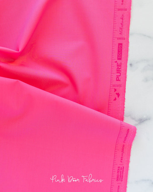 Cotton quilting fabric pattern called 'Festival Fuchsia'. Part of the 'Pure Solids' fabric collection. Designed by Art Gallery Fabrics for fabric company Art Gallery Fabrics. SKU: PE-404. 44-45 inch width.