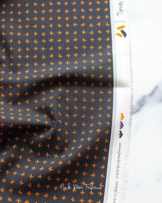 Cotton quilting fabric pattern called 'Crossed Bones in Night'. Part of the 'Spooky 'N Sweeter' fabric collection. Designed by AGF Studio for fabric company Art Gallery Fabrics. SKU: SNS-13016. 44-45 inch width.