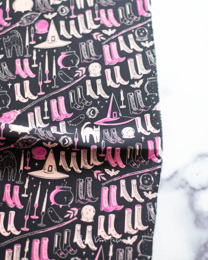 Cotton quilting fabric pattern called 'Witch's Wardrobe in Sweet'. Part of the 'Spooky 'N Sweeter' fabric collection. Designed by AGF Studio for fabric company Art Gallery Fabrics. SKU: SNS-13026. 44-45 inch width.