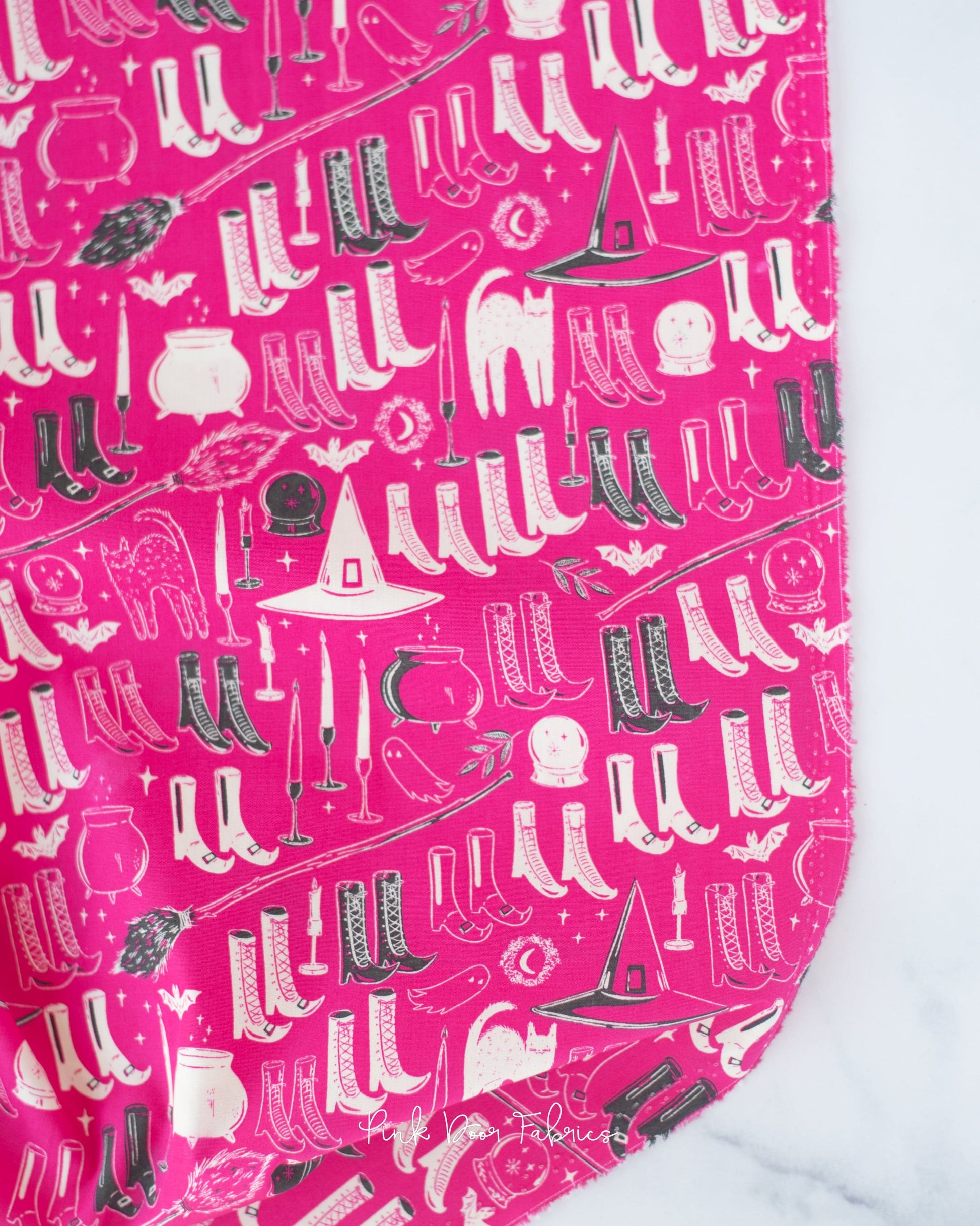 Cotton quilting fabric pattern called 'Witch's Wardrobe in Berry'. Part of the 'Sweet 'N Spookier' fabric collection. Designed by AGF Studio for fabric company Art Gallery Fabrics. SKU: SNS-13037. 44-45 inch width.