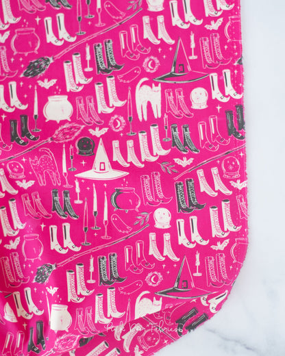 Cotton quilting fabric pattern called 'Witch's Wardrobe in Berry'. Part of the 'Sweet 'N Spookier' fabric collection. Designed by AGF Studio for fabric company Art Gallery Fabrics. SKU: SNS-13037. 44-45 inch width.
