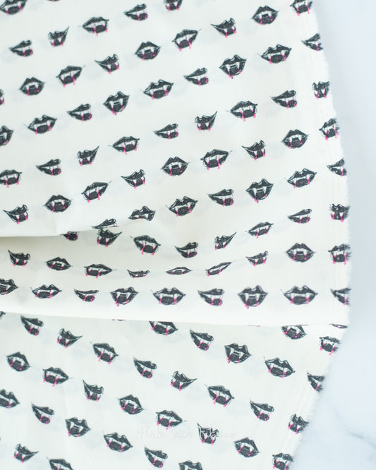 Cotton quilting fabric pattern called 'Fangtastic Lips'. Part of the 'Sweet 'N Spookier' fabric collection. Designed by AGF Studio for fabric company Art Gallery Fabrics. SKU: SNS-13040. 44-45 inch width.