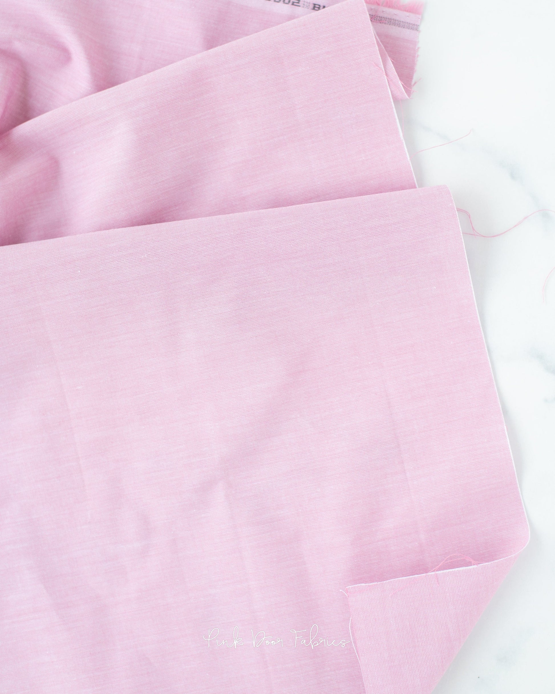 Chambray quilting fabric pattern called 'Blush'. Part of the 'Chambray Solids' fabric collection. Designed by Tilda Fabrics for the Tilda Fabrics fabric company. SKU: 160002. 44-45 inch width.